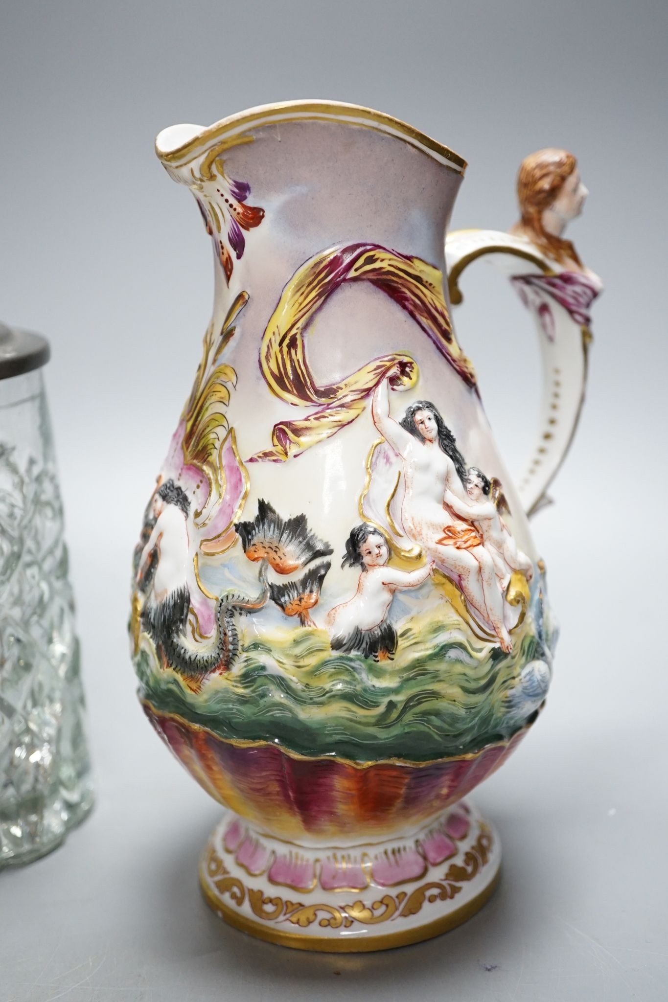 An Italian porcelain lidded tankard and matching jug, together with a cut glass lidded tankard with porcelain inset pewter lid, 22cm